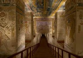 A view inside a pyramid corridor, with walls covered in hieroglyphics and ancient artwork