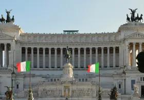 Italian government building with Italian flags displayed outside its entrance