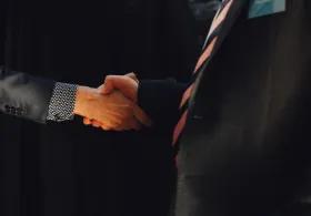 A close up two people shaking hands.