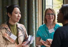 Three women engaging in conversation.