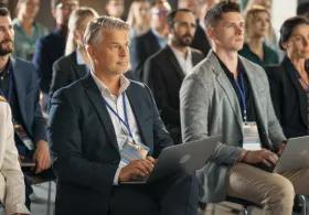 Members of an audience watching and listening to the presenter