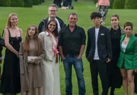 group of learners standing on grass looking at camera