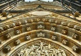 A low-angle view of a gold-toned architectural building