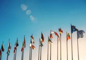 Flags of the world against a blue sky
