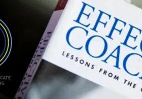 Coaching book with a coaching accreditation badge. 