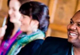 3 people listening to a seminar at a coaching group workshop.