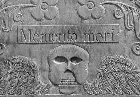 Detail from an 18th century headstone in a cemetery in Concord, Massachusetts. The winged death's head design was common in 18th century New England. "Memento mori" is Latin phrase, meaning, "Remember you will die."