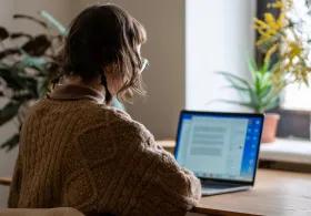 woman sat at laptop in home office