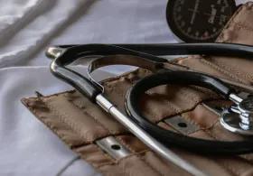 Close-up of a historical doctor's kit, a pouch including a stethoscope and other medical instruments. 