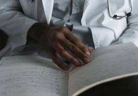 Close-Up Shot of a Doctor Reading His Notes