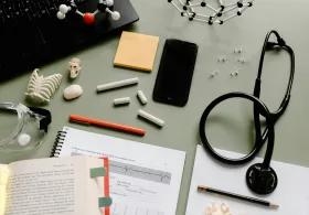 Black and Silver Headphones Beside Orange and White Pen and White Earbuds