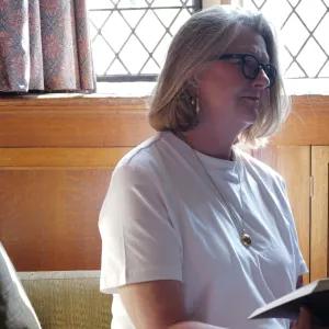 Person sat in library reading open book