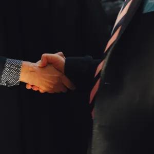 A close up two people shaking hands.