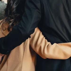 Couple with arms around each other in support