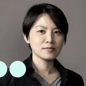 Asian woman with short hair looking at camera