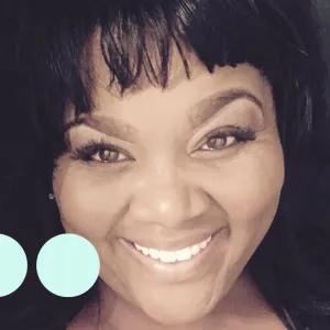 Black woman taking selfie, smiling for photo 