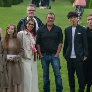group of learners standing on grass looking at camera