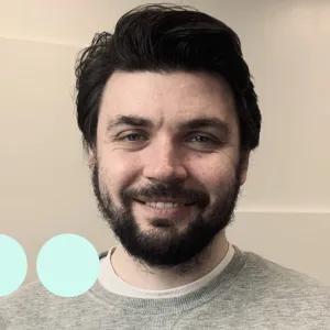 Man with dark hair and facial hair