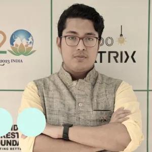 Man with glasses stood with arms folded 