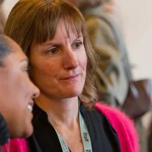 Staff talking with a new student at event