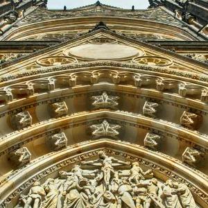 A low-angle view of a gold-toned architectural building
