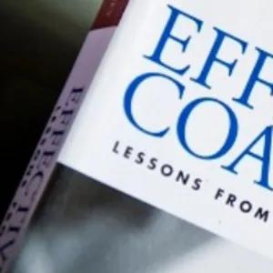 Coaching book with a coaching accreditation badge. 