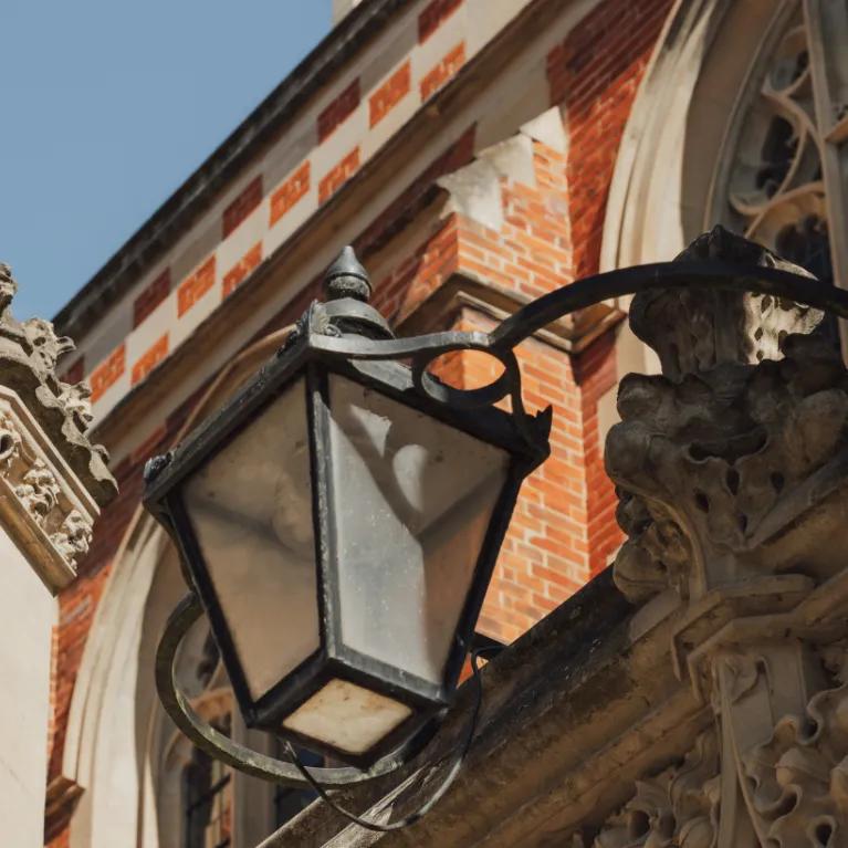 Looking up at Cambridge architecture with blue sky behind