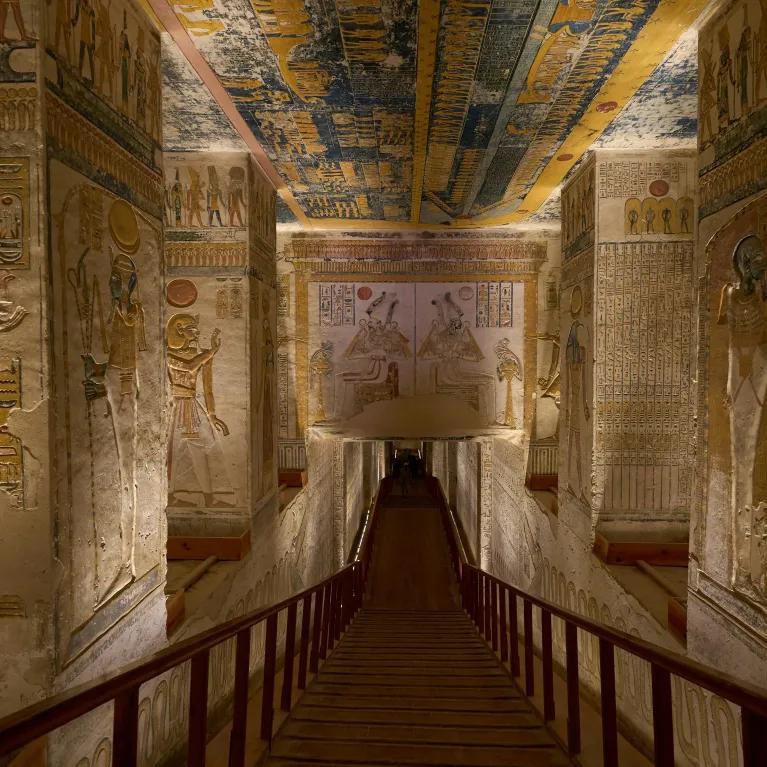 A view inside a pyramid corridor, with walls covered in hieroglyphics and ancient artwork