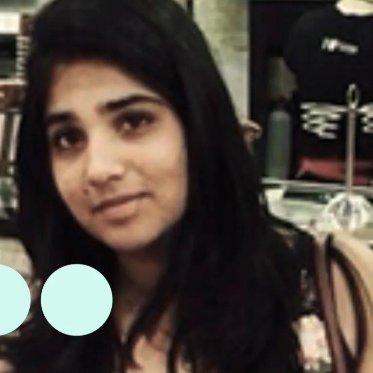 Image of woman with long black hair looking directly into camera