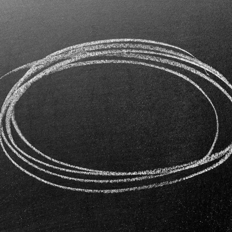 chalk circle drawn on a blackboard