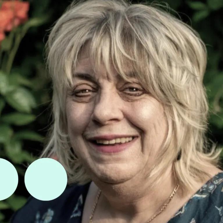 Image of older woman, smiling at camera