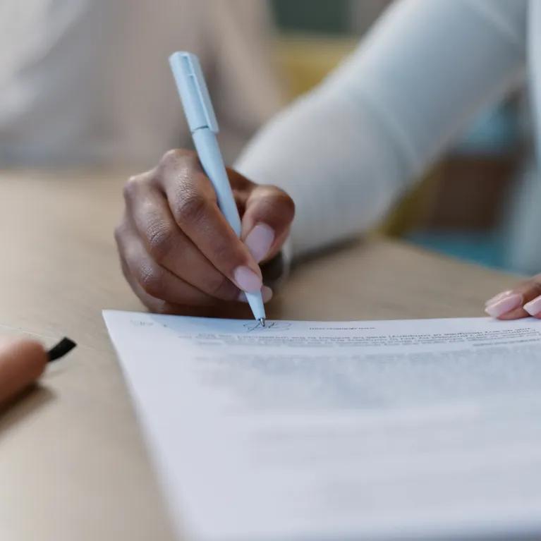Person sitting at a desk writing a report