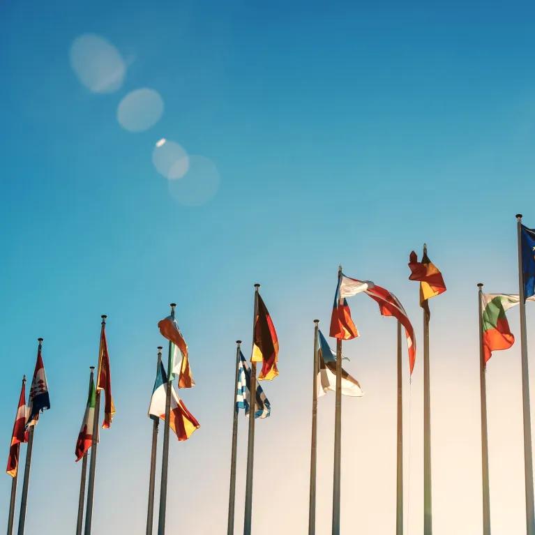 Flags of the world against a blue sky