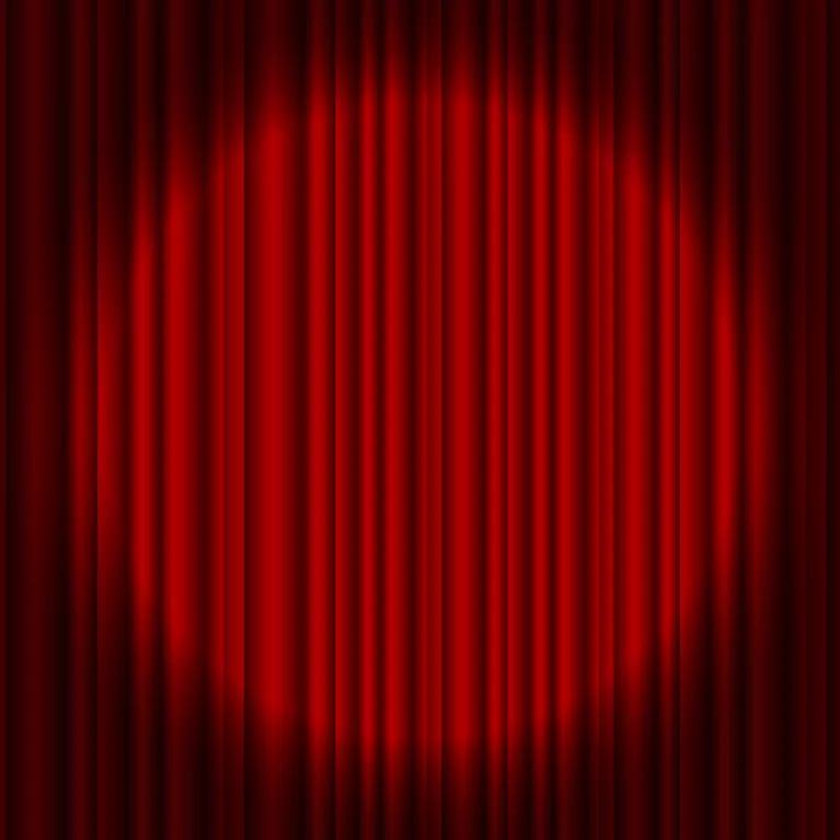 Spotlight shining on red stage curtains