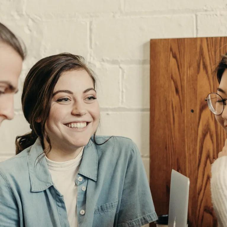 Group of learners smiling and interacting