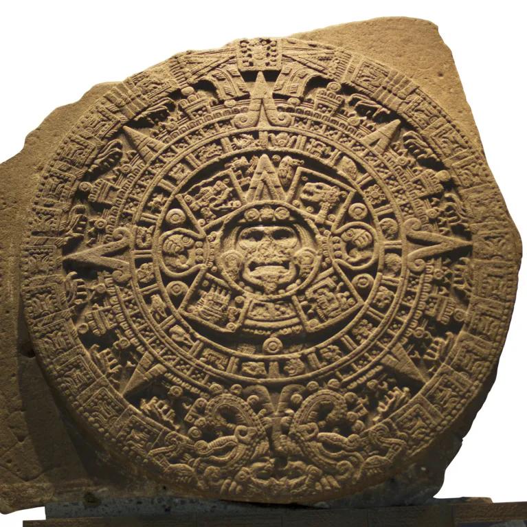 An stone or piece of clay engraved in an intricate, circular pattern. 