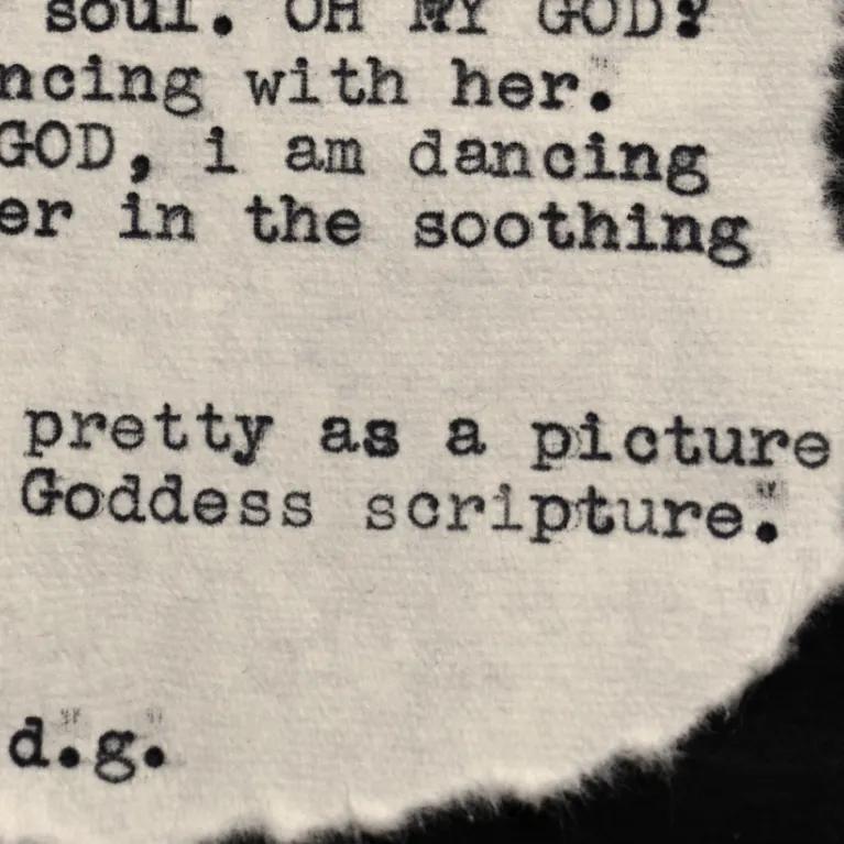 a piece of text, likely a poem or short verse, printed or typed on a torn or irregularly shaped piece of fabric, possibly linen or cotton. 