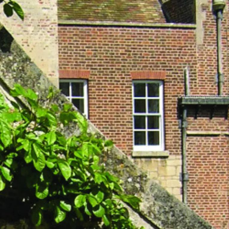 A close up photo of Madingley hall roof, building and windows.  