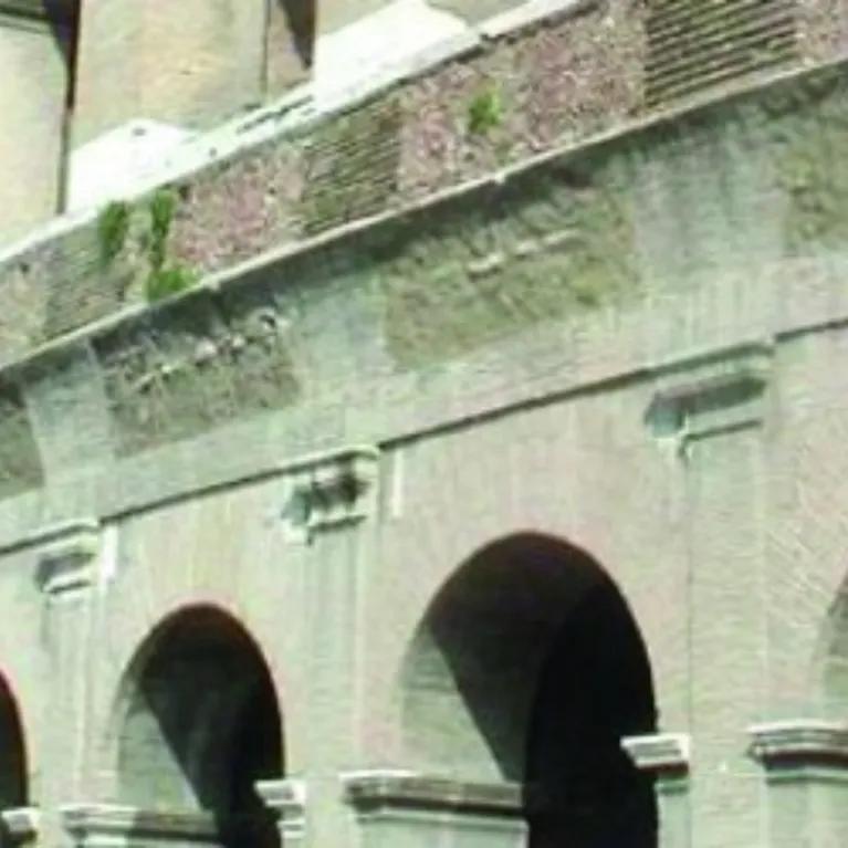 A close-up view of the exterior of the Colosseum in Rome, Italy.