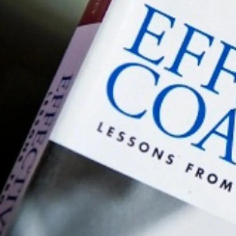 Coaching book with a coaching accreditation badge. 