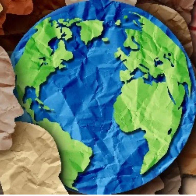 Origami globe with surrounding paper silhouettes of human faces, arranged in a circle.