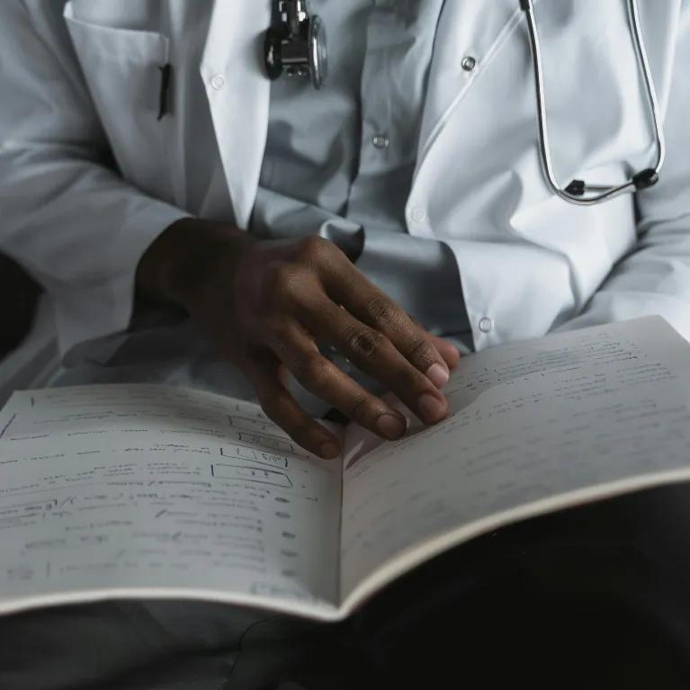 Close-Up Shot of a Doctor Reading His Notes