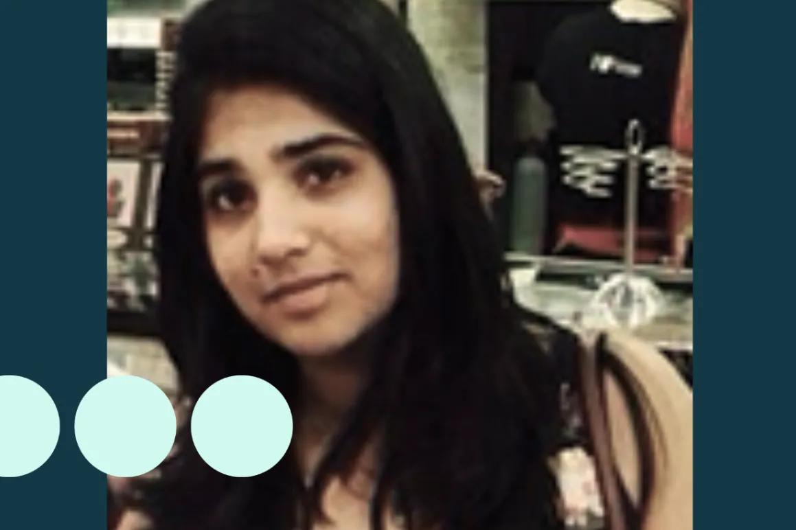 Image of woman with long black hair looking directly into camera