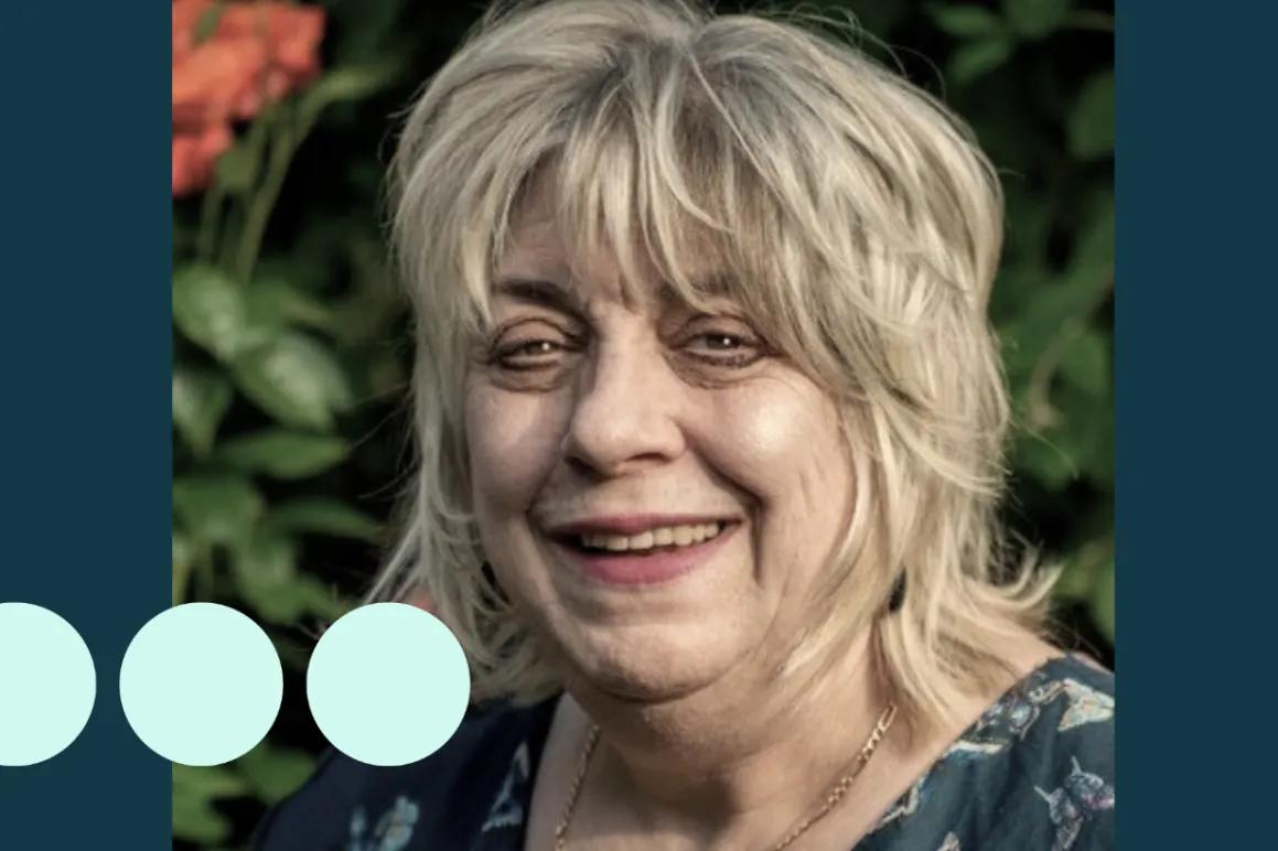 Image of older woman, smiling at camera