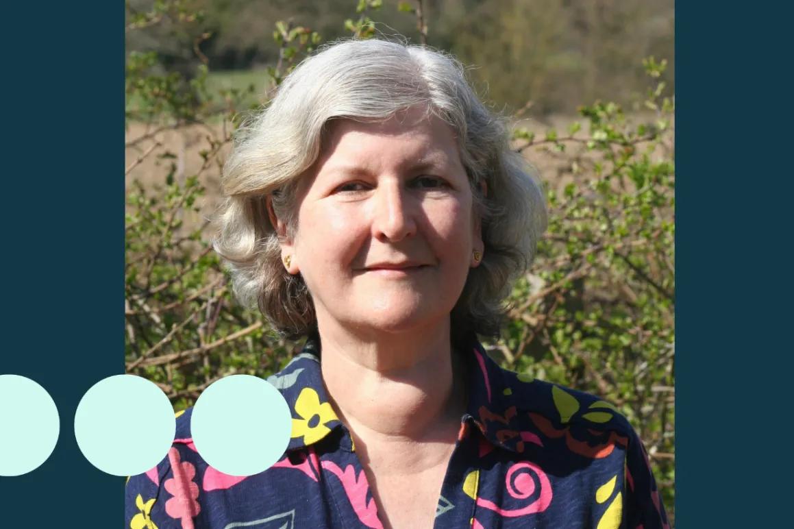 Older woman with silver short wavy hair 