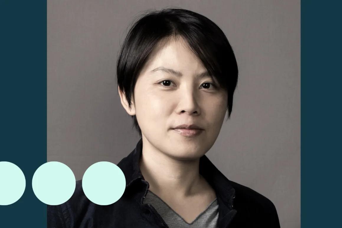 Asian woman with short hair looking at camera