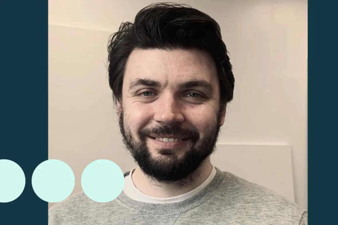 Man with dark hair and facial hair