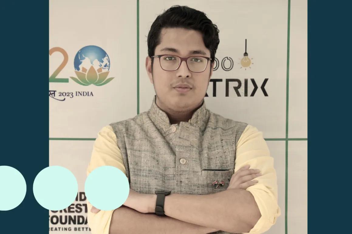 Man with glasses stood with arms folded 