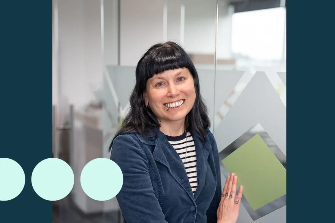Women smiling with black hair and blue jacket