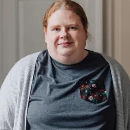 women smiling in grey top